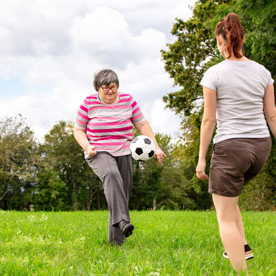 Mental,Disabled,Woman,Is,Playing,Soccer,To,Train,Her,Motor